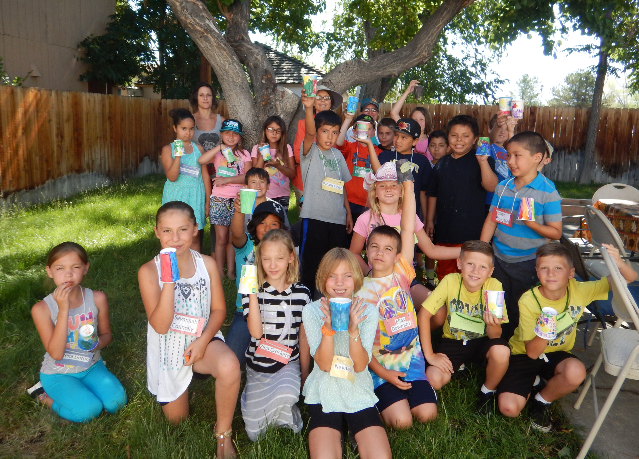Kids in Victoria Hamilton's 3rd grade Bishop Elementary School Class proudly show off their painted flower pots at their Garden Party.